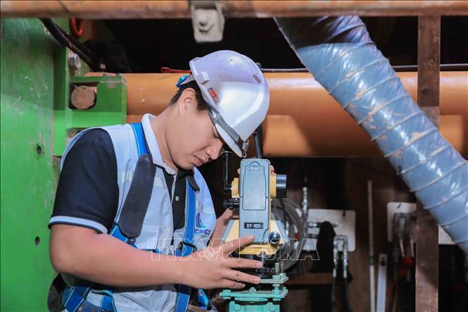 Kỹ sư điều khiển máy laser định vị tim tuyến, bảo đảm hướng khoan chính xác theo thiết kế kỹ thuật của dự án. (Ảnh: Phan Phương/TTXVN)