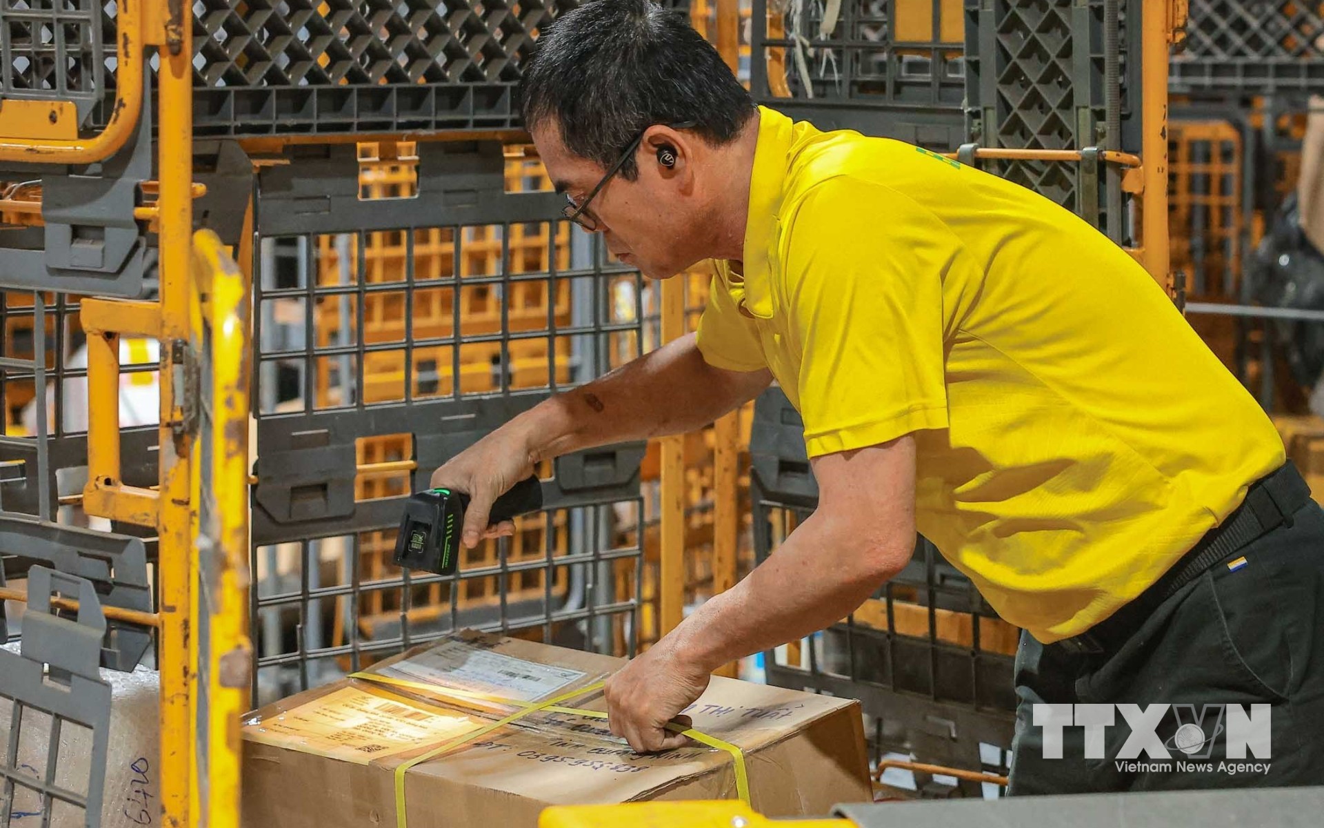 Nhân viên Tổng Công ty Bưu điện Việt Nam sử dụng thiết bị quét mã vạch (QR) để cập nhật, theo dõi hành trình bưu kiện, bảo đảm phân loại chính xác và chuyển phát đến đúng địa chỉ, nâng cao hiệu quả và độ tin cậy trong toàn bộ quy trình vận chuyển. (Ảnh: Hoàng Hiếu/TTXVN)